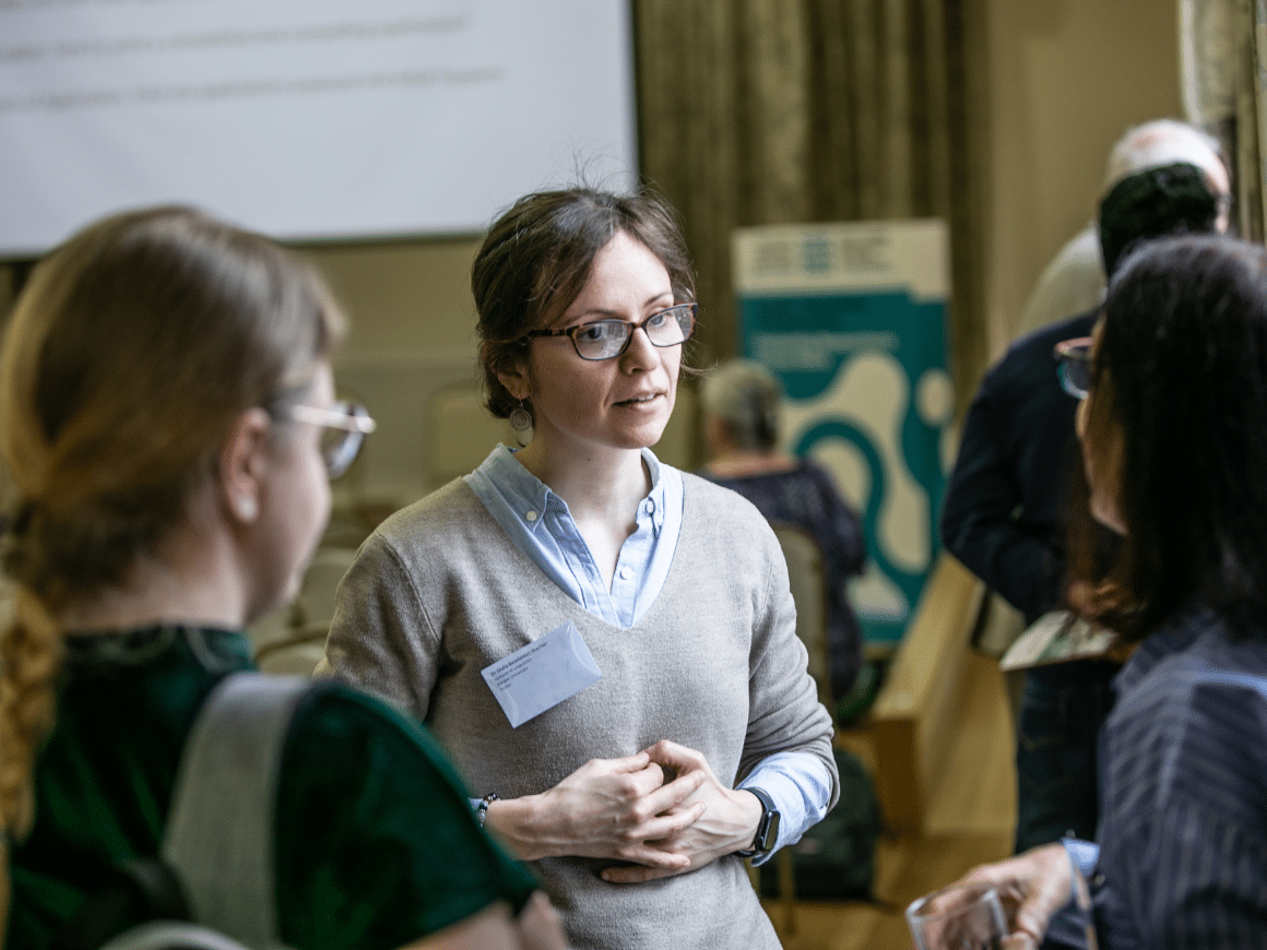 Three women early-career researchers in discussion at the Learned Society of Wales colloquium in Bangor, 2024.